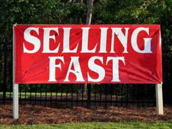 A red sign that says selling fast on it.